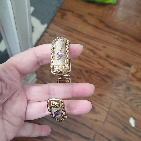 Gold tone Intricate bracelet w/ raised pattern with amethyst cor stones on Hinge - Picture 4 of 5